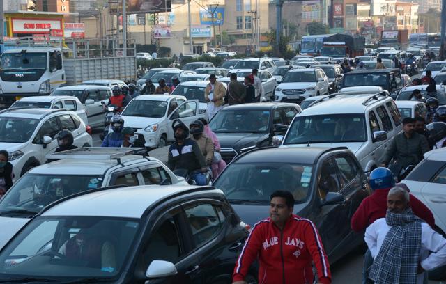Commuters stuck in a traffic jam in Zirakpur due to the two hour-long road show. (Sant Arora/HT)