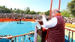 Union Home Minister Amit Shah addressing a public meeting at Mauranipur in Jhansi on Monday. (ANI)