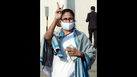 West Bengal Chief Minister Mamata Banerjee shows a victory sign as she celebrates Trinamool Congress (TMC) win in the Bidhannagar Municipal Corporation elections, outside Netaji Subhash Chandra Bose International Airport, in Kolkata on Monday. (Utpal Sarkar)
