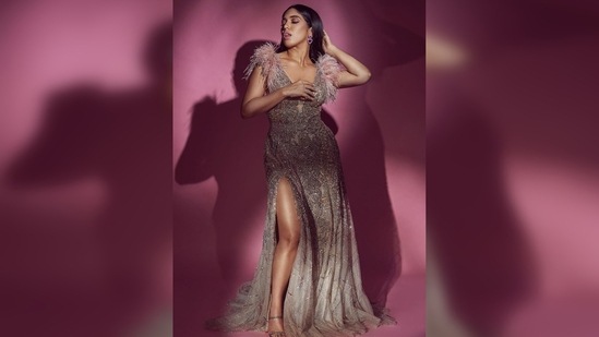 In the pictures, Bhumi Pednekar can be seen donning a gorgeous embellished thigh-high slit gown.(Instagram/@bhumipednekar)