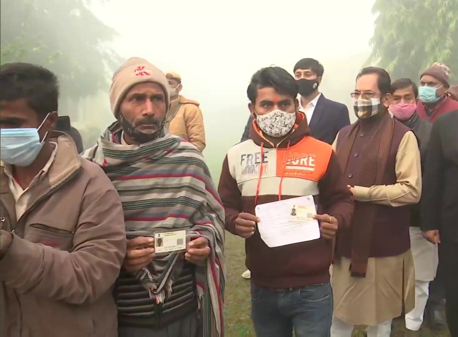 Union minister Mukhtar Abbas Naqvi in queue with voters in Rampur, Uttar Pradesh. Union minister Mukhtar Abbas Naqvi in queue with voters in Rampur, Uttar Pradesh.