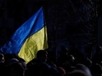A person holding the Ukrainian flag during a protest in Kyiv, Ukraine.