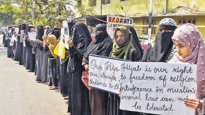 Women and girls holding placards stage a peaceful protest over the hijab ban imposed in the few colleges in Karnataka, near Shanthi Nagar Hockey Stadium, in Hyderabad on Tuesday. (ANI) Women and girls holding placards stage a peaceful protest over the hijab ban imposed in the few colleges in Karnataka, near Shanthi Nagar Hockey Stadium, in Hyderabad on Tuesday. (ANI)