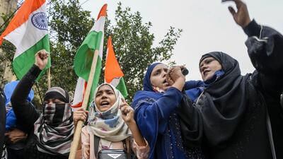 Indian Muslim women in Kolkata shout slogans during a protest against banning Muslim girls wearing hijab from attending classes at some schools in Karnataka. (AP)