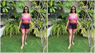 Mrunal paired a bright pink bra with a pair of colourful shorts. The black shorts came decorated in shades of pink and orange at the borders and completed her look for the day. (Instagram/@mrunalthakur)