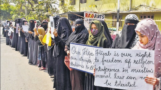 Women and girls holding placards stage a peaceful protest over the hijab ban imposed in the few colleges in Karnataka, near Shanthi Nagar Hockey Stadium, in Hyderabad on Tuesday. (ANI)
