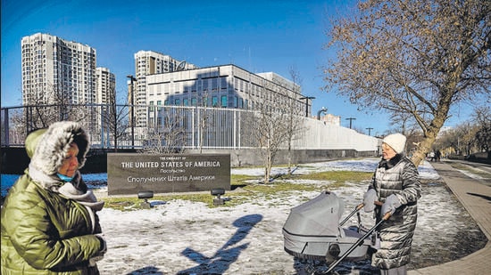 People pass by the closed US embassy in Kyiv, on Tuesday. American citizens have already been urged to leave Ukraine, with the West accusing Russia of sending more than 100,000 soldiers to encircle the former Soviet state. (AFP)