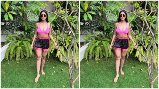 Mrunal paired a bright pink bra with a pair of colourful shorts. The black shorts came decorated in shades of pink and orange at the borders and completed her look for the day.(Instagram/@mrunalthakur)