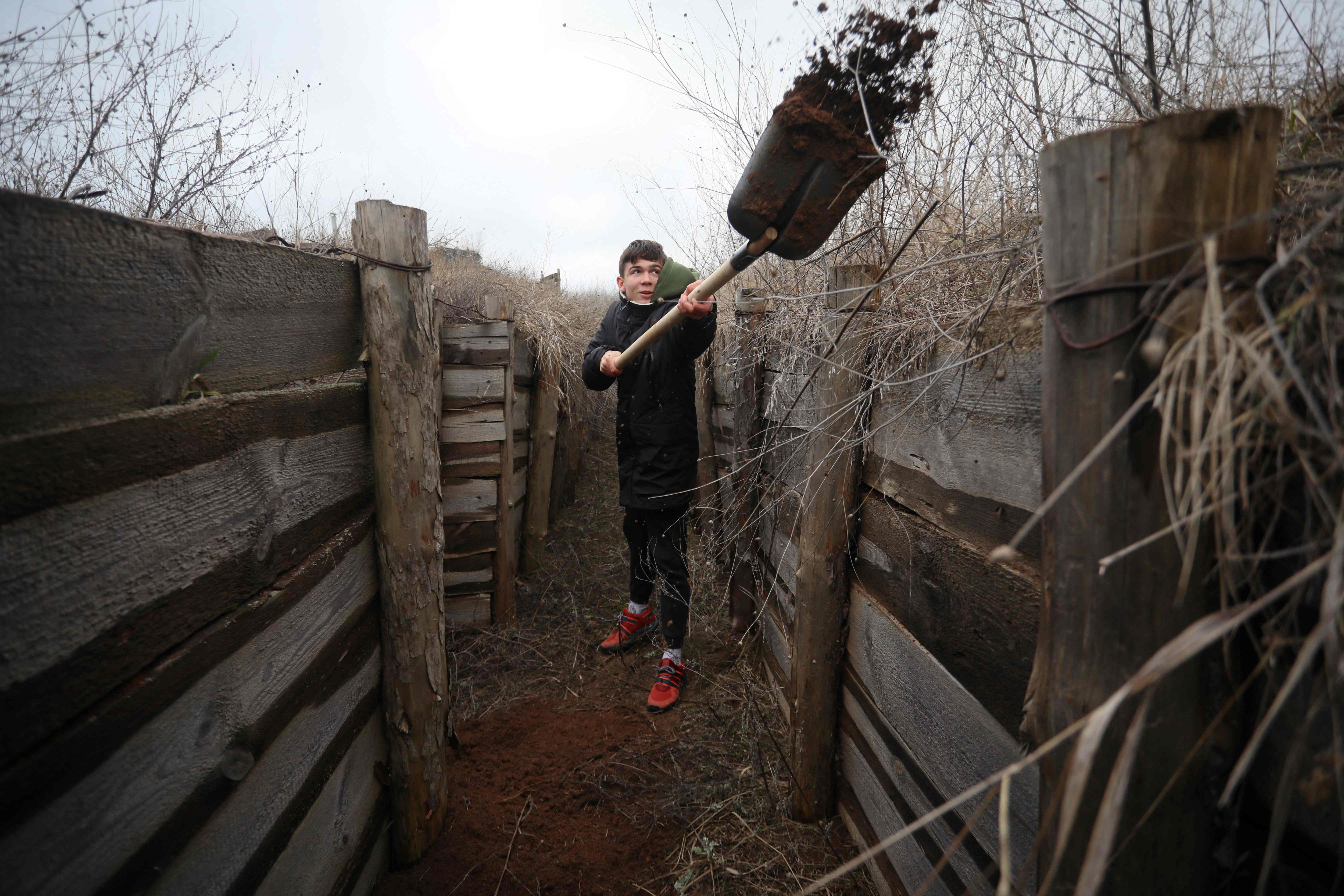 A Ukrainian teenager digs trenches for soldiers serving on their country's eastern front and facing off with Russian-backed separatists, near the eastern Ukraine village of Chervone, Mariupol region. (AFP) A Ukrainian teenager digs trenches for soldiers serving on their country's eastern front and facing off with Russian-backed separatists, near the eastern Ukraine village of Chervone, Mariupol region. (AFP)
