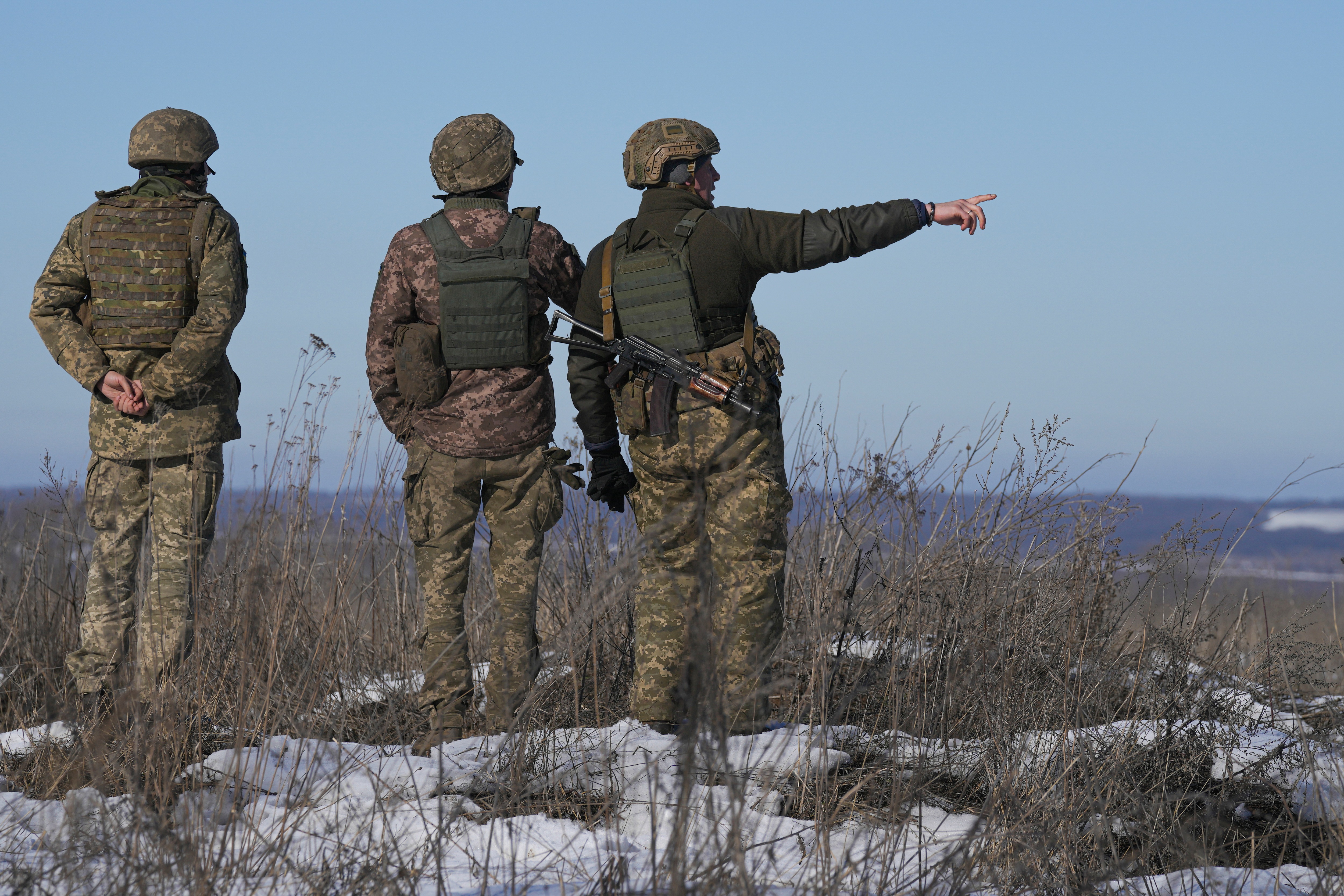 Ukrainian servicemen survey the impact areas from shells that landed close to their positions during the night on a front line outside Popasna, Luhansk region, eastern Ukraine, Monday, Feb. 14, 2022.&nbsp; (AP)