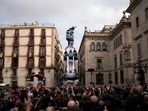 Members of the "Castellers de Poble Sec" complete their human tower during the Saint Eulàlia fesitivities in Barcelona, Spain. Members of the "Castellers de Poble Sec" complete their human tower during the Saint Eulàlia fesitivities in Barcelona, Spain.