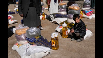 A boy sits next to food supplies during a distribution of humanitarian aid for poor families, Kabul, Afghanistan, February 16, 2022. (AP) A boy sits next to food supplies during a distribution of humanitarian aid for poor families, Kabul, Afghanistan, February 16, 2022. (AP)