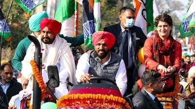 Punjab CM Charanjit Singh Channi and Congress general secretary Priyanka Gandhi Vadra during a roadshow in Ropar ahead of the Punjab Assembly elections. (ANI)