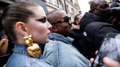 Kanye West, centre, attends the Kenzo fall-winter 22/23 men's collection, in Paris, Sunday, Jan. 23, 2022. (AP Photo/Lewis Joly) (AP) Kanye West, centre, attends the Kenzo fall-winter 22/23 men's collection, in Paris, Sunday, Jan. 23, 2022. (AP Photo/Lewis Joly) (AP)