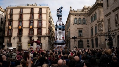 Members of the "Castellers de Poble Sec" complete their human tower during the Saint Eulàlia fesitivities in Barcelona, Spain. (AP) Members of the "Castellers de Poble Sec" complete their human tower during the Saint Eulàlia fesitivities in Barcelona, Spain. (AP)
