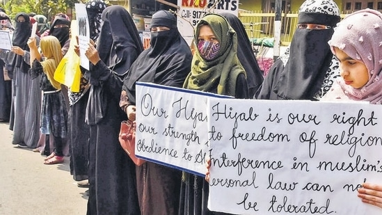 Women and girls holding placards stage a peaceful protest over the hijab ban imposed in the few colleges in Karnataka, near Shanthi Nagar Hockey Stadium, in Hyderabad on Tuesday. (ANI)