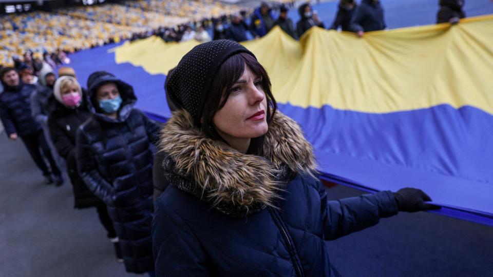 Residents carry Ukrainian national flag as they gather in the Olympic Stadium in Ukraine’s Kyiv to mark the Unity Day, the day Western intelligence agencies allegedly said they’d be invaded by Russia (Reuters) Residents carry Ukrainian national flag as they gather in the Olympic Stadium in Ukraine’s Kyiv to mark the Unity Day, the day Western intelligence agencies allegedly said they’d be invaded by Russia (Reuters)