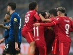 Liverpool's Mohamed Salah celebrates with his teammates after scoring his side's second goal during the Champions League, round of 16, first leg soccer match between Inter Milan and Liverpool at the San Siro stadium in Milan, Italy,