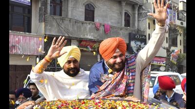 Punjab chief minister Charanjit Singh Channi with Punjab Congress president and candidate from Amritsar East Constituency Navjot Singh Sidhu during a road show in Amritsar. (Sameer Sehgal /HT) Punjab chief minister Charanjit Singh Channi with Punjab Congress president and candidate from Amritsar East Constituency Navjot Singh Sidhu during a road show in Amritsar. (Sameer Sehgal /HT)