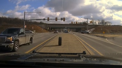 The image, taken from the video shared by a police department in Pennsylvania, shows the tyre approaching the police car just before smashing the windshield. (Facebook/@Spring Township Police Department)
