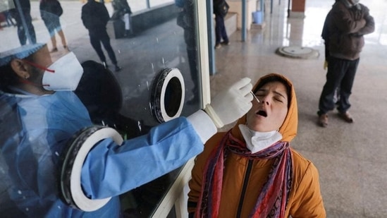 A healthcare worker collects a swab sample from a woman to test for Covid-19. (Reuters Archive) A healthcare worker collects a swab sample from a woman to test for Covid-19. (Reuters Archive)