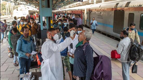 Healthcare worker collects swab sample of the passenger for Covid-19 test at Dadar station, in Mumbai on Thursday. (Pratik Chorge/HT Photo)