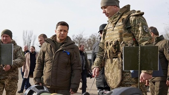 Ukrainian President Volodymyr Zelenskyy inspects weapons during a visit to Ukrainian coast guards in Mariupol, Donetsk region, eastern Ukraine (AP)
