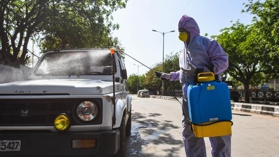 A Delhi civic body worker sprays disinfectant on a police vehicle on day 13 of the 21-day nationwide lockdown to check the spread of coronavirus.(Amal KS/HT PHOTO) A Delhi civic body worker sprays disinfectant on a police vehicle on day 13 of the 21-day nationwide lockdown to check the spread of coronavirus.(Amal KS/HT PHOTO)