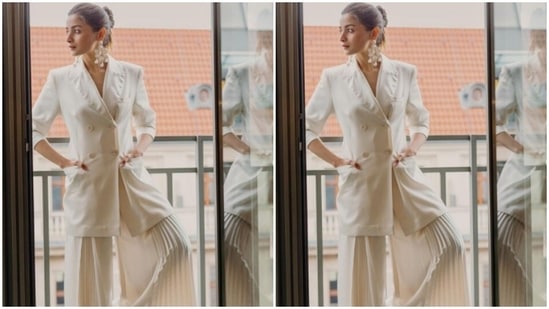 Alia paired a white blazer with a pair of white satin palazzos. The palazzos came with pleated details and wide legs.(Instagram/@aliaabhatt)