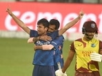 Indian bowler Ravi Bishoni celebrates with his teammate Yuzvendra Chahal after dismissing West Indies batter Brandon King (R) during 2nd T20 cricket match at Eden Garden in Kolkata, Friday,Feb. 18, 2022.(PTI)