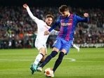 Napoli's Dries Mertens, left, and Barcelona's Gerard Pique vie for the ball during the Europa League soccer match between Barcelona and Napoli in Barcelona, Spain. Napoli's Dries Mertens, left, and Barcelona's Gerard Pique vie for the ball during the Europa League soccer match between Barcelona and Napoli in Barcelona, Spain.