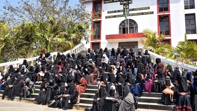 Burqa and hijab-clad students protest outside the Shivamogga District collector's office, in Shivamogga. (PTI) Burqa and hijab-clad students protest outside the Shivamogga District collector's office, in Shivamogga. (PTI)