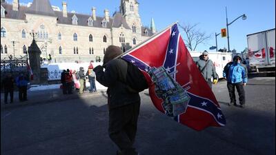A supporter carries a US Confederate flag during the Freedom Convoy protesting Covid-19 vaccine mandates and restrictions in front of Parliament on January 29. A private members bill tabled in the Canadian parliament is seeking to ban symbols of hate like the Confederate flag and the swastika. (AFP) A supporter carries a US Confederate flag during the Freedom Convoy protesting Covid-19 vaccine mandates and restrictions in front of Parliament on January 29. A private members bill tabled in the Canadian parliament is seeking to ban symbols of hate like the Confederate flag and the swastika. (AFP)