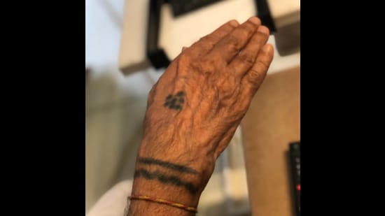 As a five-year-old, Vithalbhai Joshi, now 89, selected a double band on the wrist, drawn in the traditional Trajva style, to represent a watch. (Photo courtesy Shomil Shah)