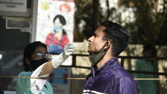 A health worker collects swab samples of a man for Covid-19 testing, in Gurugram. (Parveen Kumar/HT PHOTO) A health worker collects swab samples of a man for Covid-19 testing, in Gurugram. (Parveen Kumar/HT PHOTO)