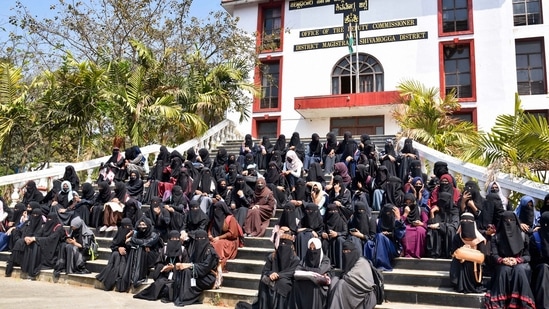 Burqa and hijab-clad students protest outside the Shivamogga District collector's office, in Shivamogga.(PTI)