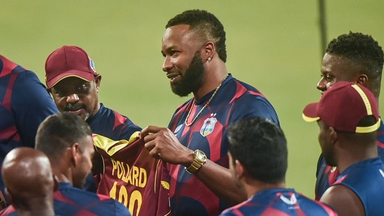 Kolkata: West Indies captain Kieron Pollard with teammates before start of the 2nd T20 cricket match against India, at Eden Garden in Kolkata, Friday,Feb. 18, 2022. Pollard is playing his 100th T20 international match.(PTI)