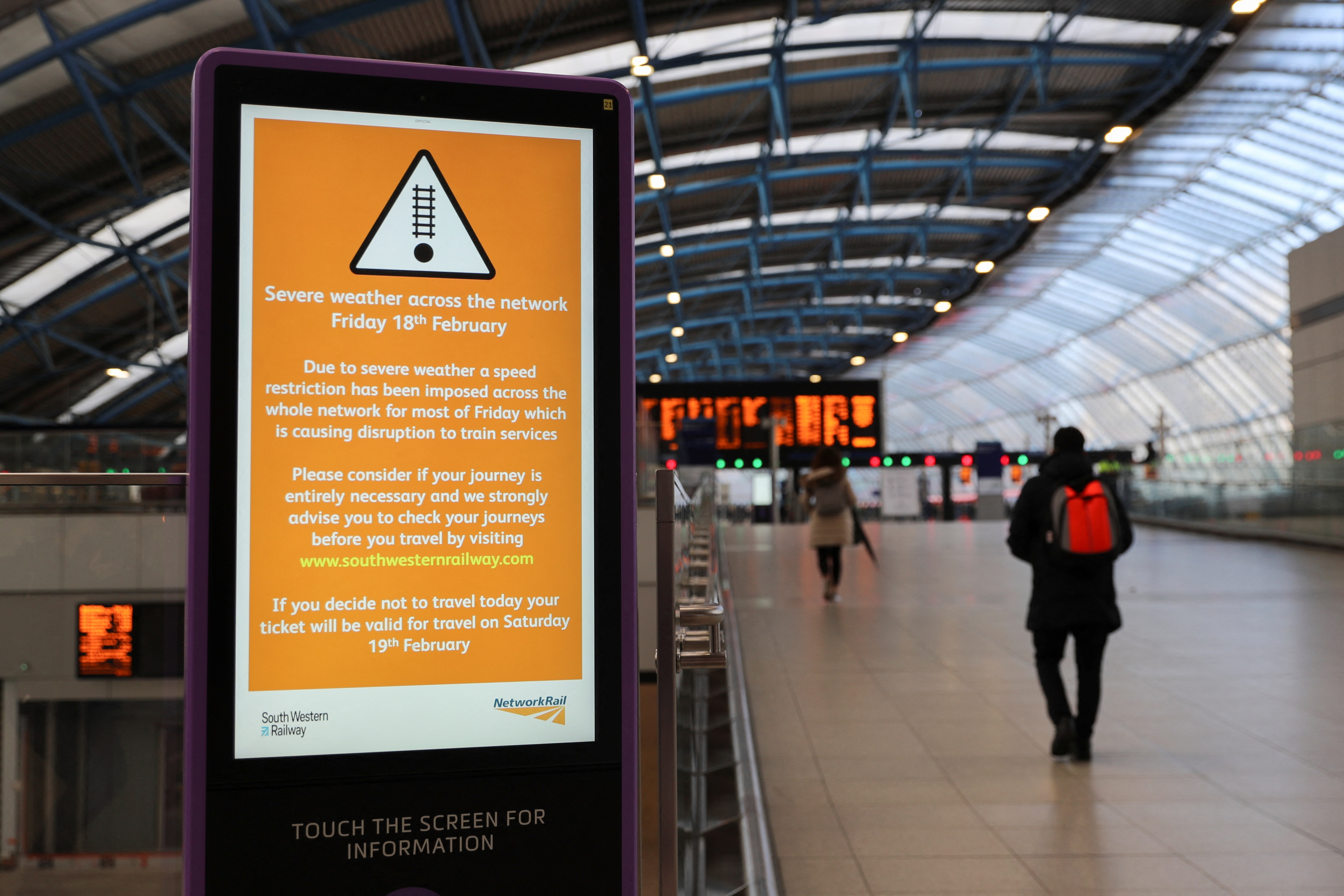 A person walks past a sign at Waterloo station, as a red weather warning was issued due to Storm Eunice, in London, Britain, February 18, 2022.&nbsp; (REUTERS)