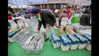 A polling official takes out an Electronic Voting Machine (EVM) from the case at a distribution centre on the eve of Punjab Assembly elections, in Amritsar on Saturday. (Raminder Pal Singh) A polling official takes out an Electronic Voting Machine (EVM) from the case at a distribution centre on the eve of Punjab Assembly elections, in Amritsar on Saturday. (Raminder Pal Singh)