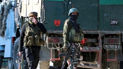 Security personnel approach near an encounter site, in Shopian on Saturday. (ANI Photo) (Imran Nissar)