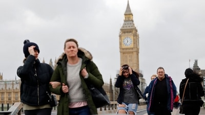 People struggle in the wind as they walk across Westminster Bridge, near the Houses of Parliament in central London on February 18 as Storm Eunice brings high winds across the country. (AFP) People struggle in the wind as they walk across Westminster Bridge, near the Houses of Parliament in central London on February 18 as Storm Eunice brings high winds across the country. (AFP)