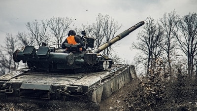 A service member of the Ukrainian Naval Infantry Corps (Marine Corps) drives a tank during drills at a training ground in an unknown location in Ukraine. (Reuters)&nbsp; (via REUTERS)