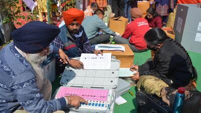 Polling staff giving a final check to EVM machines at Government College, Dera Bassi, on Saturday, ahead of the elections on Sunday. (Sant Arora/HT)