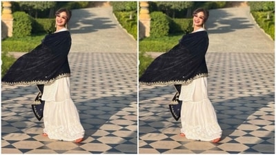 Patralekhaa paired a white chikankari kurta with a pair of white sharara intricately embroidered in white resham threads. Patralekhaa teamed it with a velvet black dupatta decorated in white threads at the borders. (Instagram/@patralekhaa)