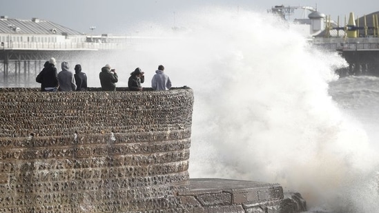 People take pictures as waves break on during Storm Eunice, in Brighton, Britain, February 18, 2022. REUTERS/Peter Nicholls(REUTERS)