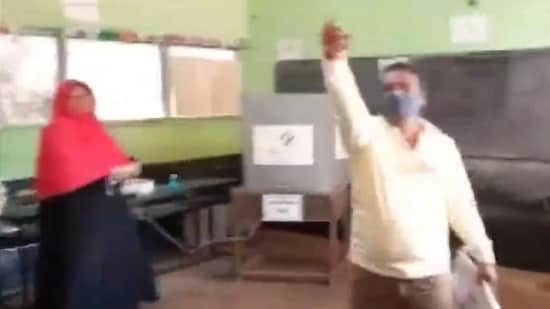A member of the BJP’s polling booth committee in Madurai district was seen loudly raising his objections when a hijab-clad woman voter entered the room.(Screengrab from video/ANI)