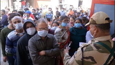Voters waiting to cast their votes for the Punjab assembly elections, at a polling booth in Jalandhar on Sunday. (ANI Photo)