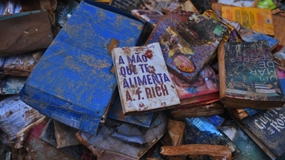 Damaged books are seen on the street after heavy rains flooded the bookstore in Petropolis, Brazil. (AFP) Damaged books are seen on the street after heavy rains flooded the bookstore in Petropolis, Brazil. (AFP)