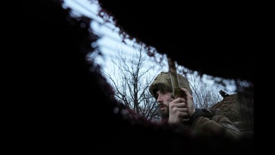 A Ukrainian service member listens to artillery shots standing in a trench on a position at the line of separation between Ukraine-held territory and rebel-held territory near Zolote, Ukraine, February 19, 2022 (AP) A Ukrainian service member listens to artillery shots standing in a trench on a position at the line of separation between Ukraine-held territory and rebel-held territory near Zolote, Ukraine, February 19, 2022 (AP)
