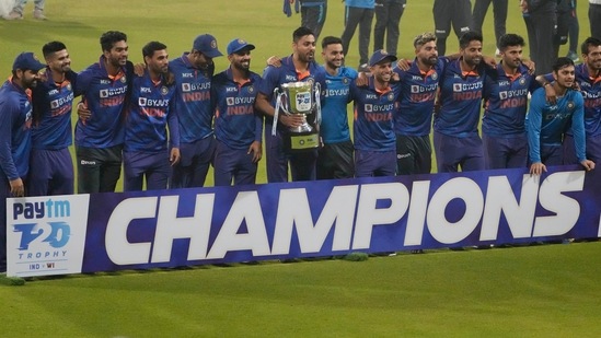Indian players pose with the winners trophy after their win in the third Twenty20 international cricket match against West Indies in Kolkata, India, Sunday, Feb. 20, 2022. Indian won the series 3-0. (AP)